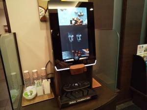 una máquina expendedora con un videojuego en el baño en Hotel Route-Inn Ashikaga Ekimae en Ashikaga