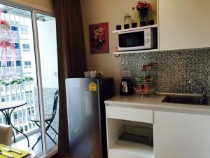 a kitchen with a refrigerator and a microwave at The Trust Huahin By Sopida in Hua Hin