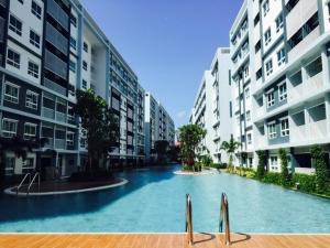 a swimming pool in the middle of two apartment buildings at The Trust Huahin By Sopida in Hua Hin