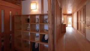 a hallway with wooden shelves in a house at Woody Island in Hakuba