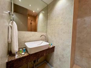 a bathroom with a sink and a mirror at YVN Tumanyan apart-hotel in Yerevan