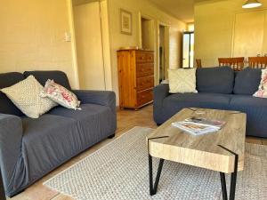a living room with two couches and a coffee table at Riverview Holiday Apartment 92 - Kalbarri WA in Kalbarri