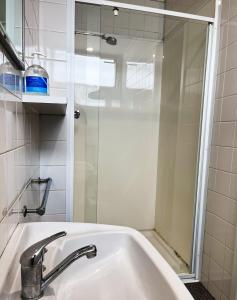 a bathroom with a sink and a shower at Manjimup Hotel in Manjimup