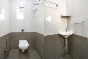 a bathroom with a toilet and a sink at FabHotel HRG Destiny in Nagpur