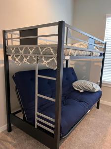 a bunk bed with a blue pillow on the bottom bunk at Charming House Downtown in Houston