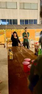 a man and a woman standing at a table at KyGo Hostels in Hyderabad