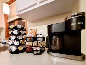a coffeemaker on a kitchen counter next to a coffee maker at Spacious Buffalo Niagara Falls Apt, Close to Buffalo Airport in Depew