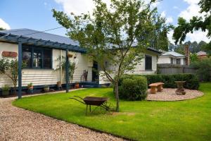 a house with a yard with a table and a bench at Sausalito- captivating 1950s retro residence in Daylesford