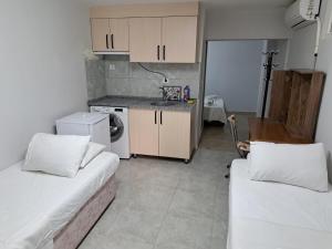 a small room with two beds and a kitchen at NEZİH SUİTS OTEL in Antalya