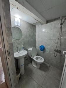 a bathroom with a toilet and a sink at NEZİH SUİTS OTEL in Antalya