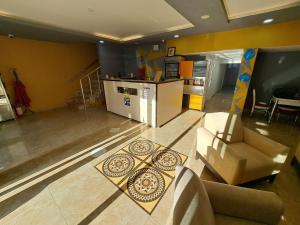 a living room with a couch and a kitchen at NEZİH SUİTS OTEL in Antalya