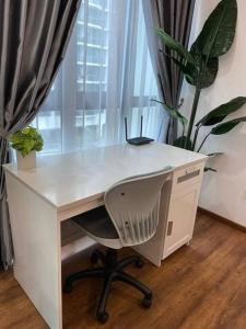 a white desk with a chair in front of a window at Vivacity Megamall Jazz Suite Kuching 8pax 3BR #Joyoustayz in Kuching