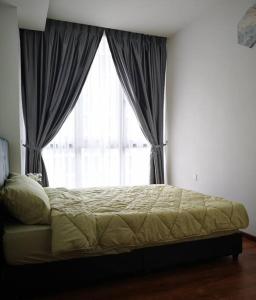 a bed in a bedroom with a large window at Vivacity Megamall Jazz Suite Kuching 8pax 3BR #Joyoustayz in Kuching