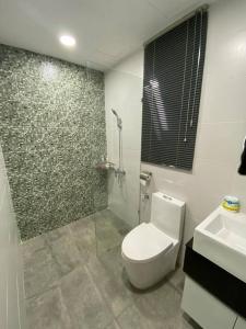 a bathroom with a toilet and a shower and a sink at Vivacity Megamall Jazz Suite Kuching 8pax 3BR #Joyoustayz in Kuching