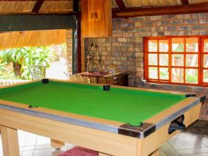 a pool table in a living room with at La Frans Guesthouse in Pretoria