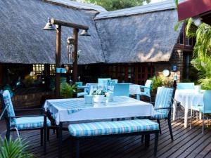 a table and chairs on a deck at La Frans Guesthouse in Pretoria