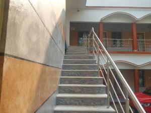 a set of stairs leading to a building at SURYA VILLA GUEST HOUSE in Tajpur