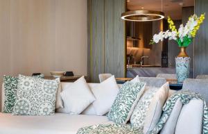 a living room with a couch and pillows at FIVE Palm Jumeirah Residences - Mint Stay in Dubai