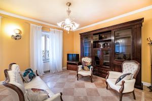 un soggiorno con divano, sedie e TV di Beautiful Villa With Private Spa - Happy Rentals ad Alviano
