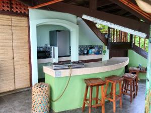 an outdoor kitchen with stools and a counter at Camotes Cay Hideaway in San Francisco