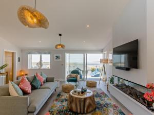 a living room with a couch and a fireplace at 4 Bed in Appledore 92041 in Appledore