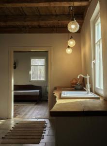 a bathroom with a sink and a bed in a room at Bliska Wioska- Dom 