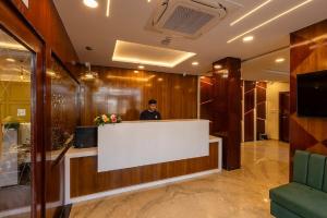 a man standing behind a counter in a lobby at Five Elements Hotels Mertiya Residency in Jodhpur