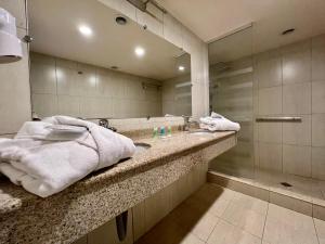 a bathroom with a sink and a large mirror at Sky Magic view Hotel in Yerevan