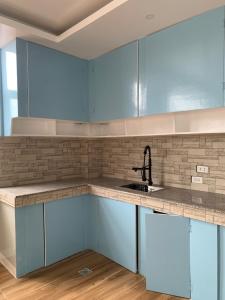 a kitchen with blue cabinets and a sink at Tending's Rendezvous in Santa Monica