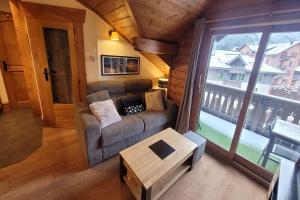 an overhead view of a living room with a couch and a table at La Ginabelle - Sauna & Swimming pool - Happy Rentals in Chamonix-Mont-Blanc