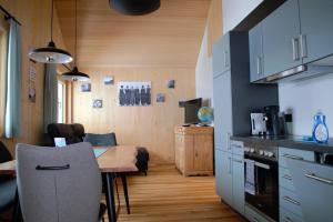 a kitchen with a table and a dining room at Ferienwohnung Mian in Bezau