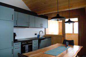 a kitchen with a wooden table and a wooden tableablish at Ferienwohnung Mian in Bezau