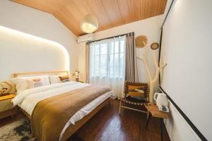 a bedroom with a large bed and a window at Millennium Ancient Town River View B&B 2 in Shanghai