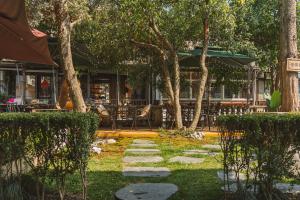 a garden with rocks and trees and a restaurant at Millennium Ancient Town River View B&B 2 in Shanghai