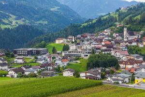 a small town on a green hill with houses at Appartements Dobler - s'Zischgn in Arzl im Pitztal