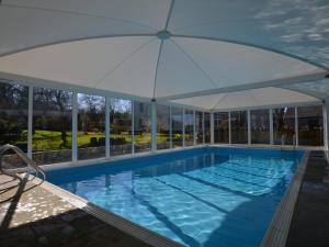 a large swimming pool with an umbrella at 4 Bed in Wedmore 58843 in Theale