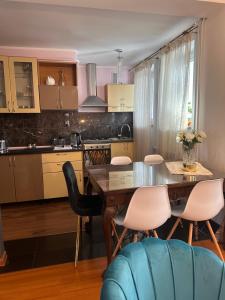 a kitchen with a dining room table and chairs at Apartament Diana - Traugutta Wrocław in Wrocław