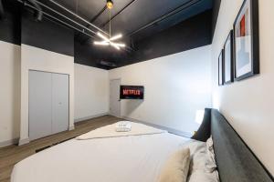 a bed in a room with a sign on the wall at Group-Friendly 6BR Luxury Suite in Prime South Loop Location with Optional Parking and Gym Access Near McCormick Place, Soldier Field and Grant Park in Chicago