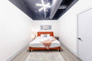 a bedroom with a bed in a white room at Group-Friendly 6BR Luxury Suite in Prime South Loop Location with Optional Parking and Gym Access Near McCormick Place, Soldier Field and Grant Park in Chicago