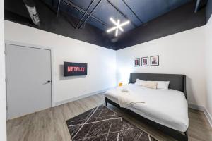 a bedroom with a king sized bed and a sign on the wall at Group-Friendly 6BR Luxury Suite in Prime South Loop Location with Optional Parking and Gym Access Near McCormick Place, Soldier Field and Grant Park in Chicago