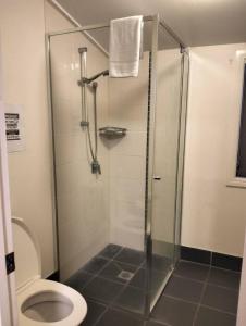 a bathroom with a shower and a toilet at cliffinn kangaroo point in Brisbane