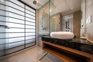 a bathroom with a white sink on a counter at Jeju Seongsan Golden View in Seogwipo