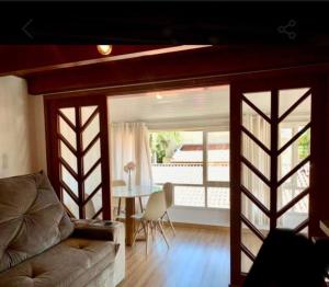 a living room with a couch and a table at No mar, condomínio pé na areia in Florianópolis