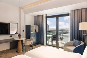 a hotel room with a view of the city at Palace Dubai Creek Harbour in Dubai