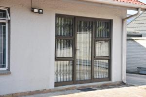 a door with glass windows on a house at CasaC Guesthouse in Sasolburg