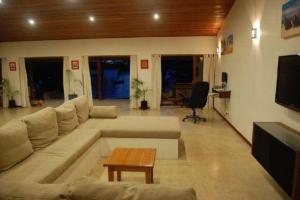 a living room with a couch and a table at 6 Krystal Waters Drive Havannah in Port Vila