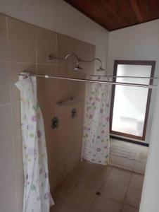 a bathroom with a shower curtain and a window at 6 Krystal Waters Drive Havannah in Port Vila
