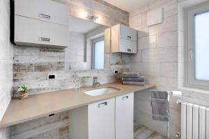 une salle de bain avec un lavabo et un miroir dans l'établissement Appartamento Zefiro Livigno, à Livigno 30 autres photos