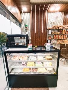 a display case in a bakery with many donuts at PLUTO HOMES Dehradun in Dehradun