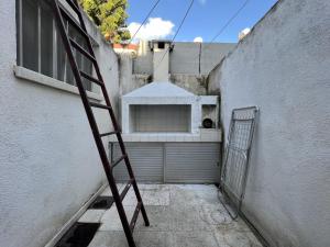 a ladder leaning against a building with a garage at Retro Hostel in Limassol